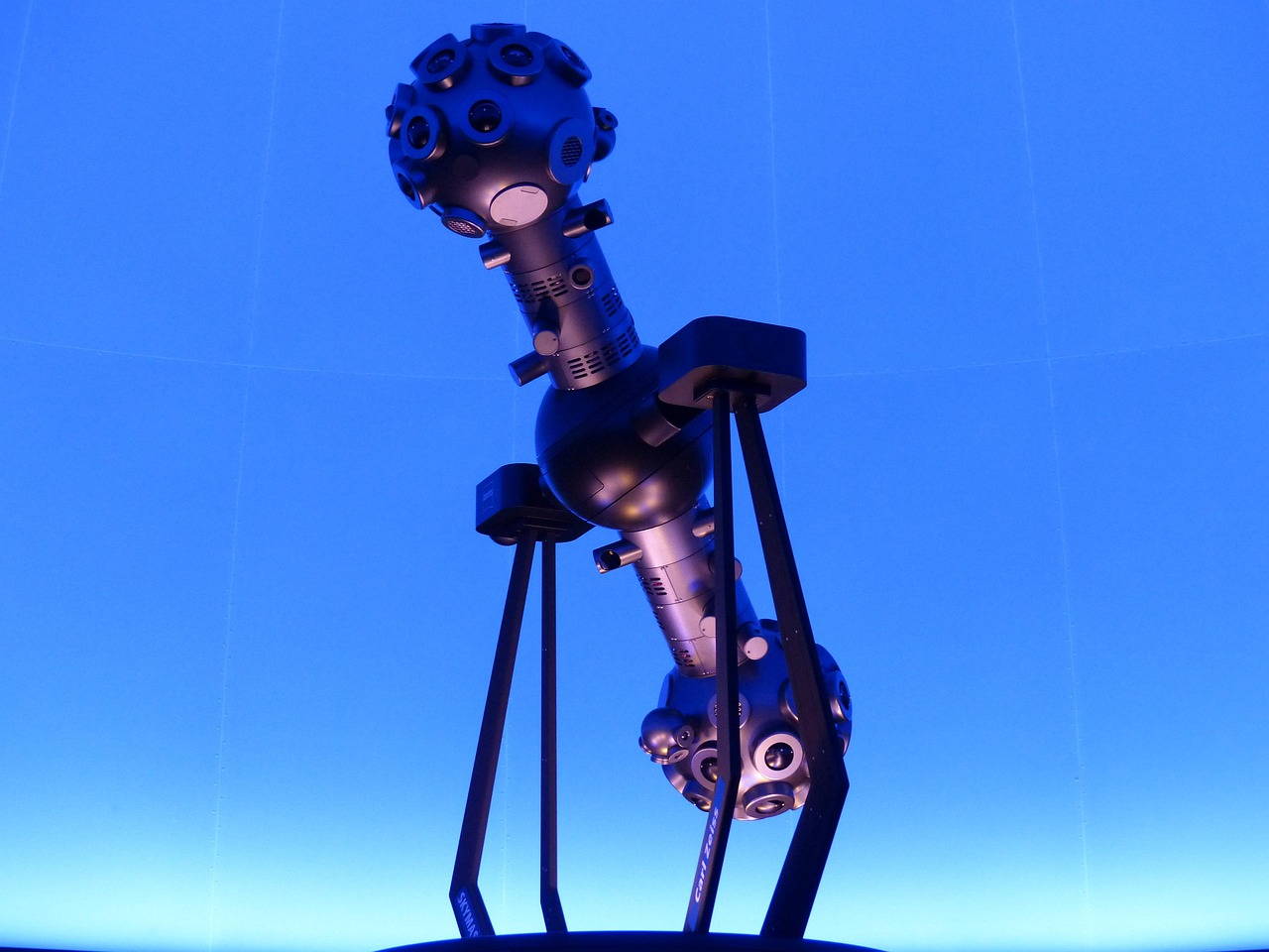 star projector, planetarium, projector, machine, futuristic, blue, bright, fluorescent, robot, like a robot
