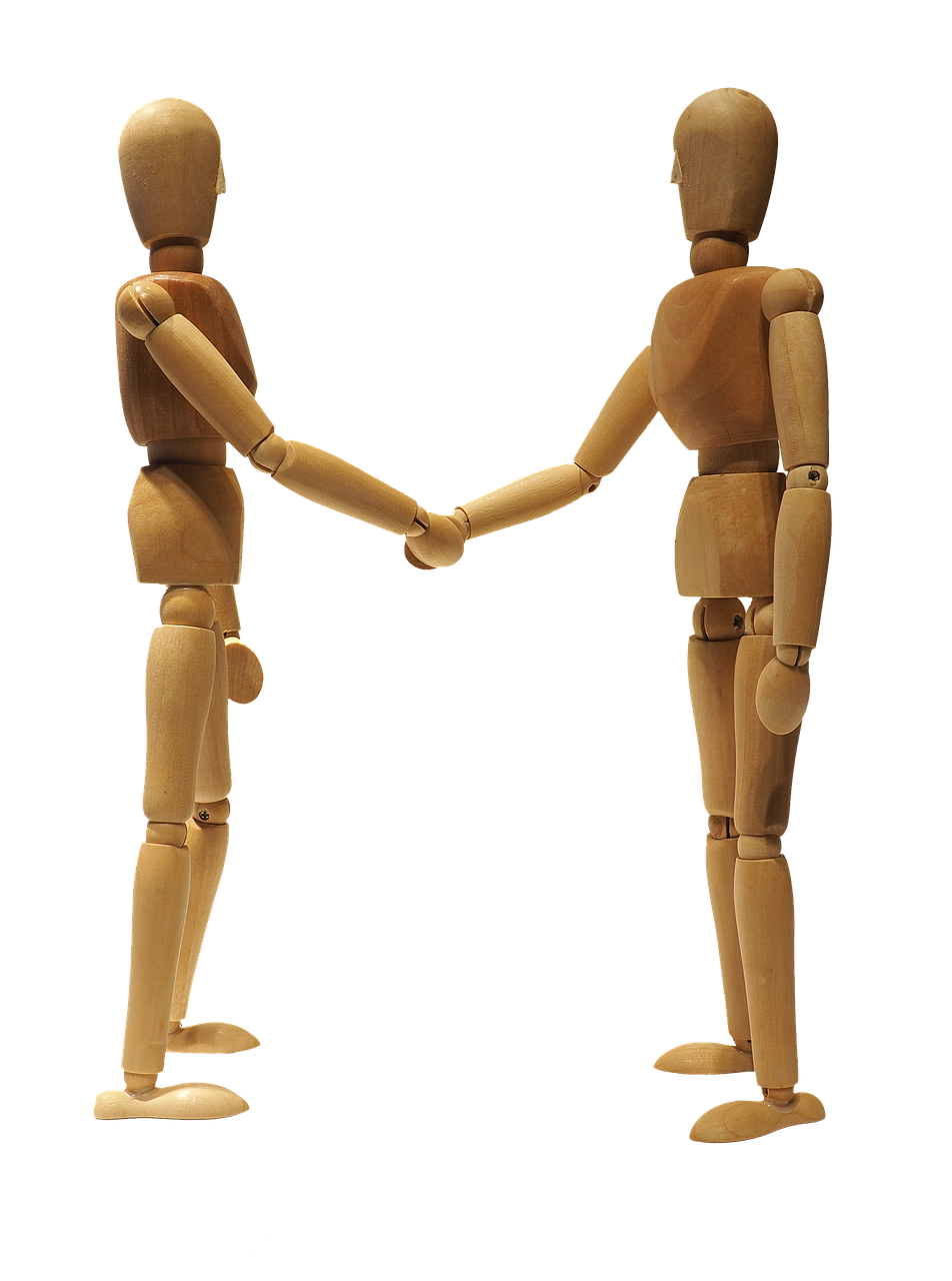 Two hands shaking, symbolizing partnership, support, and progress in healthcare